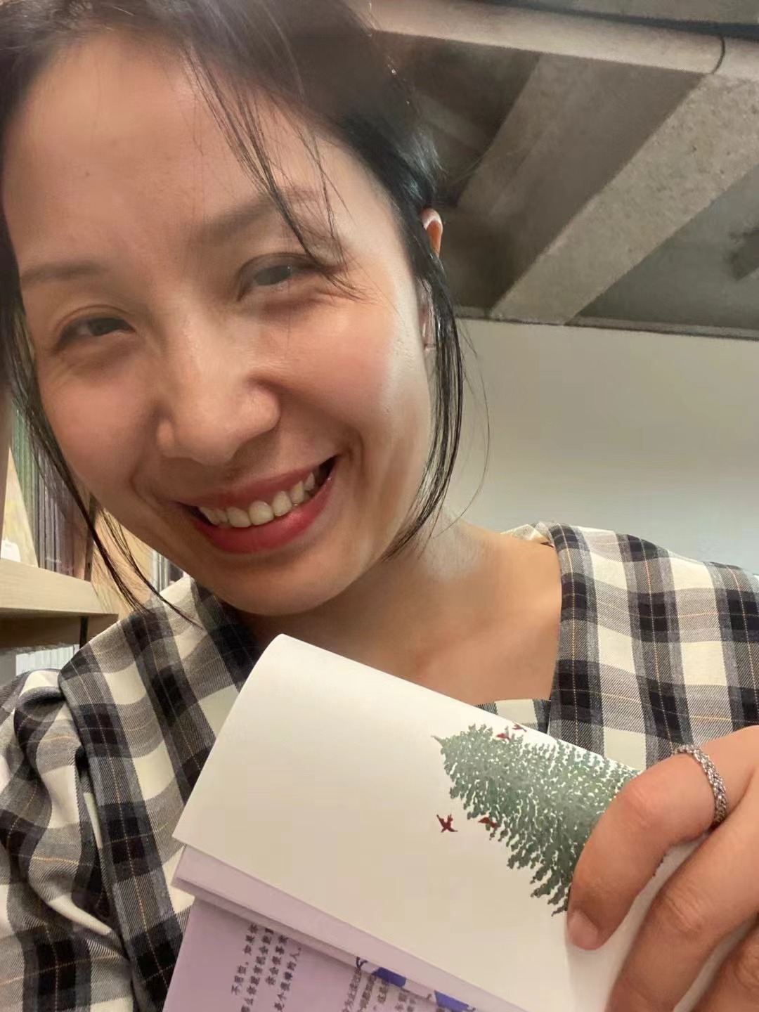 Falls smiling with a book in her hand