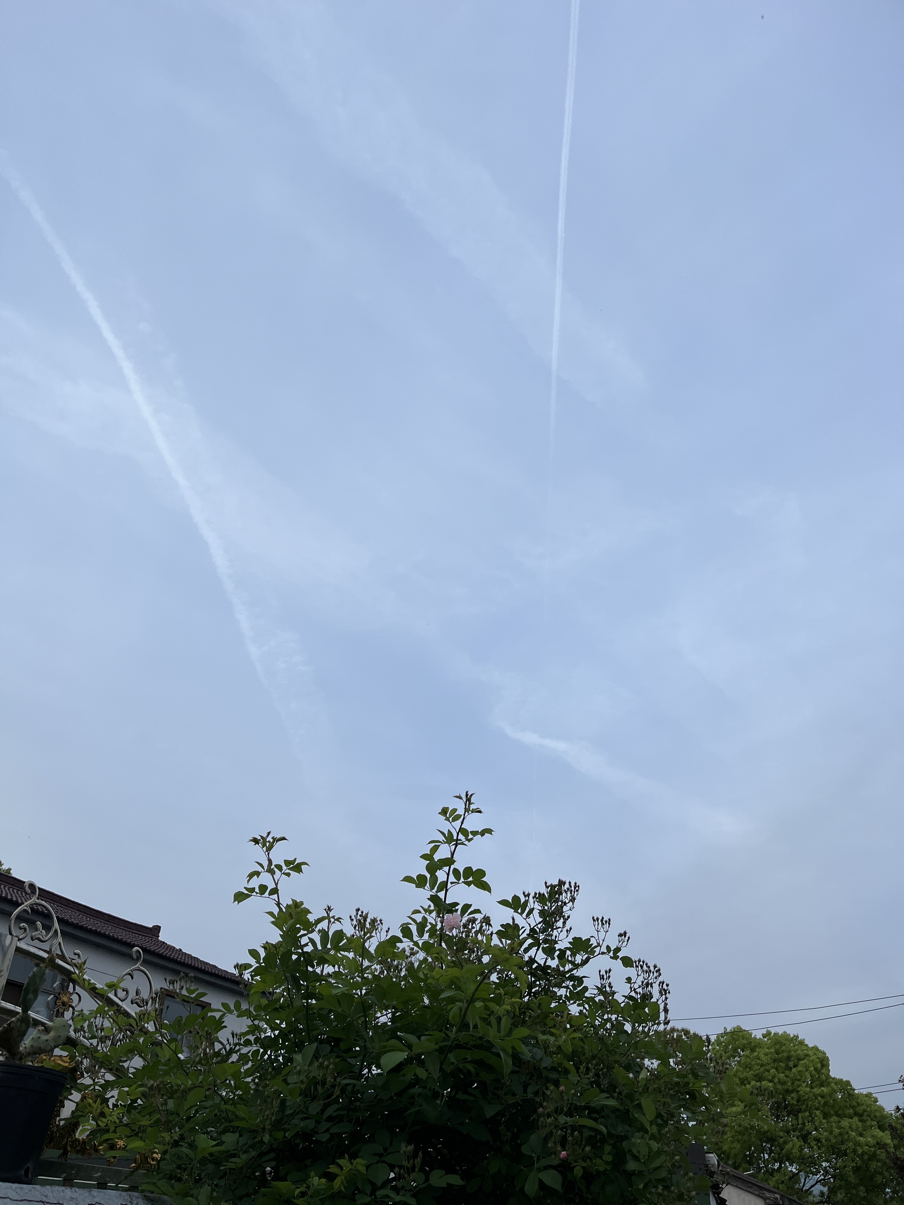 Aircraft engine emissions against the blue sky.