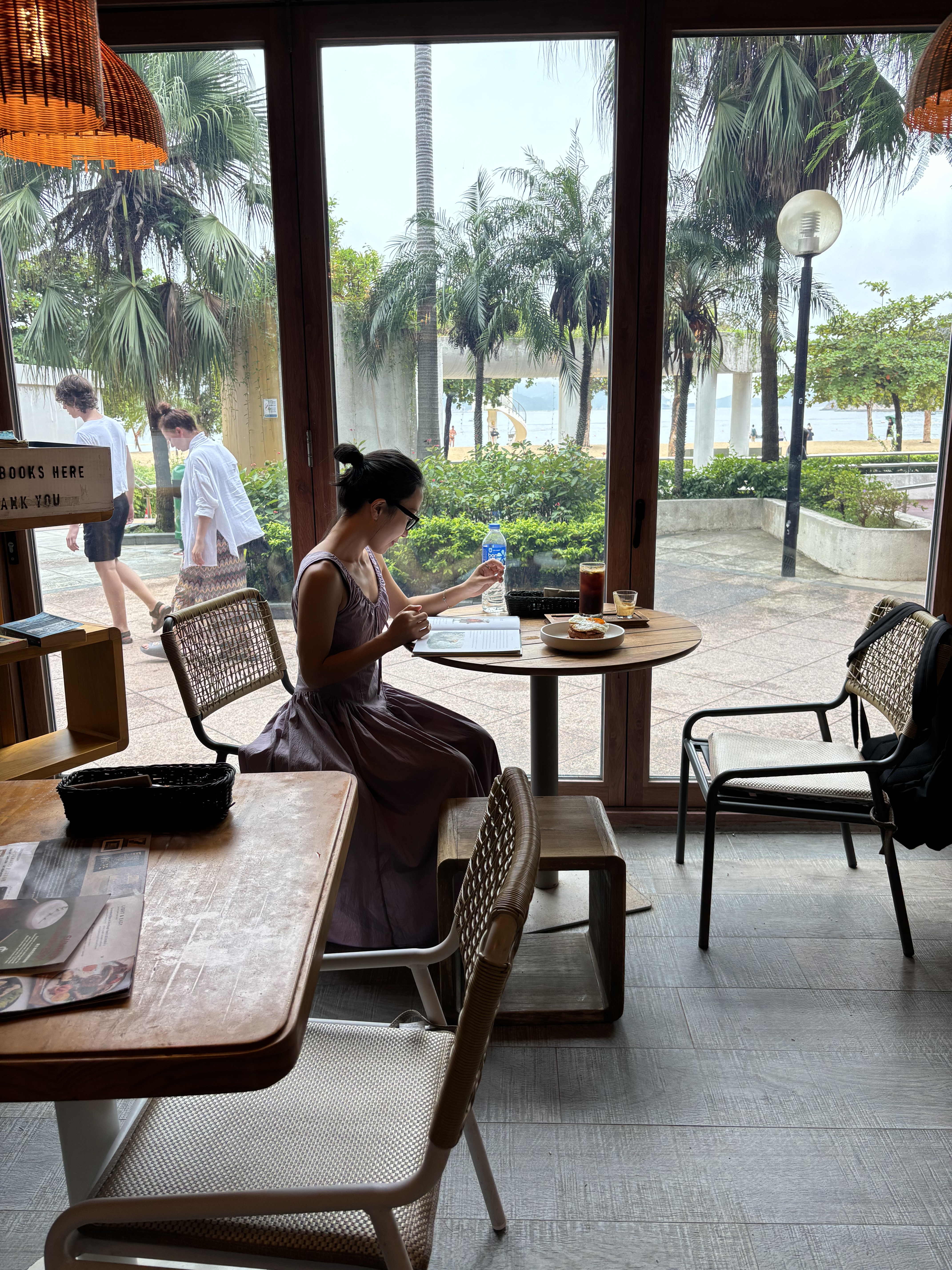 Reading while waiting for food at a local restaurant HK.