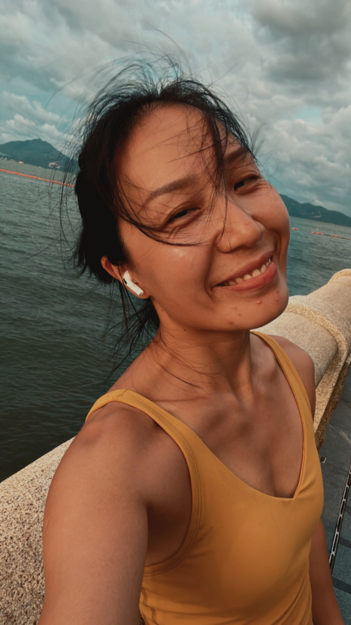 Enjoying wind by the sea after running.