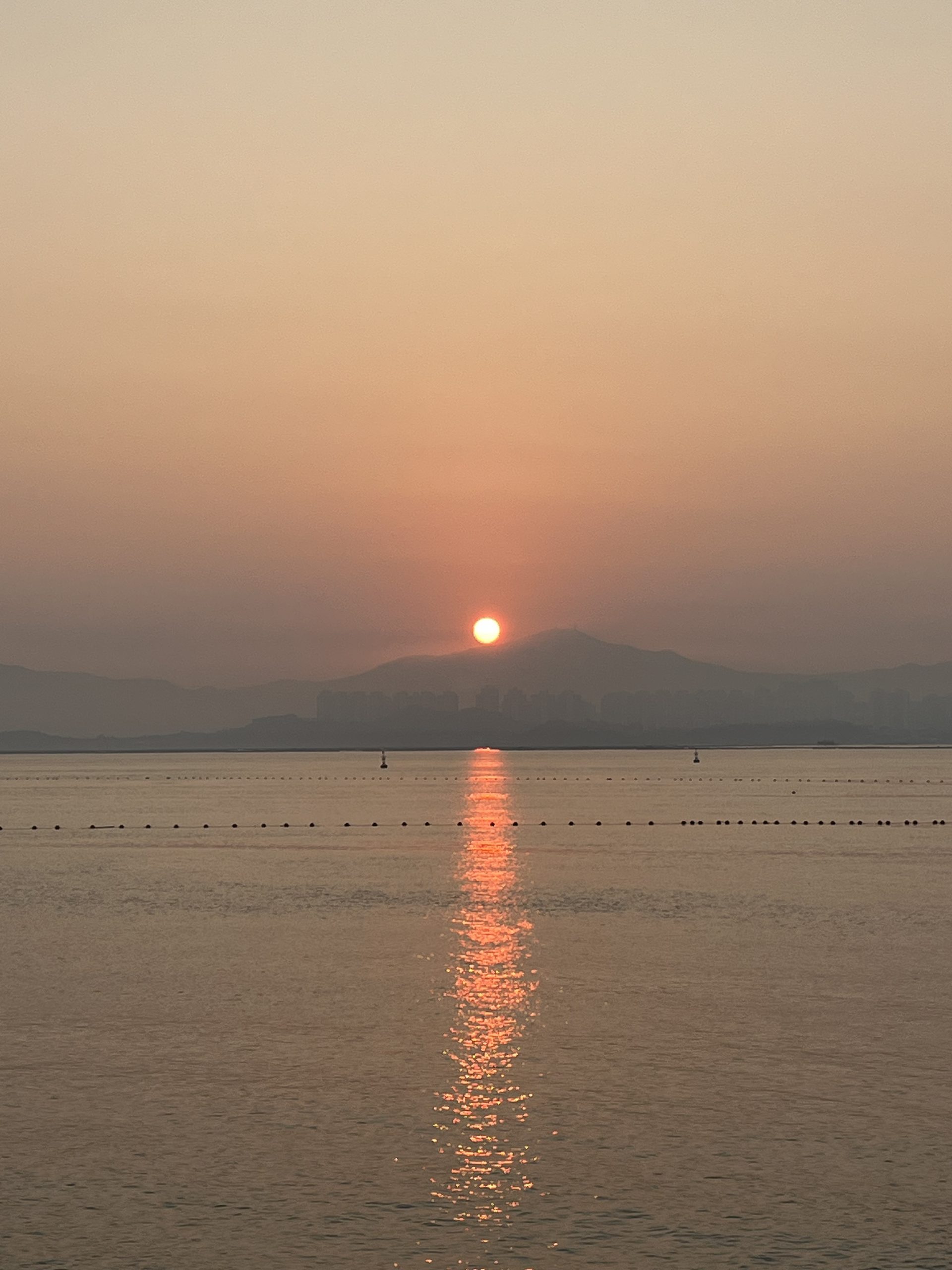 Sunrise over the sea with mountains in the background