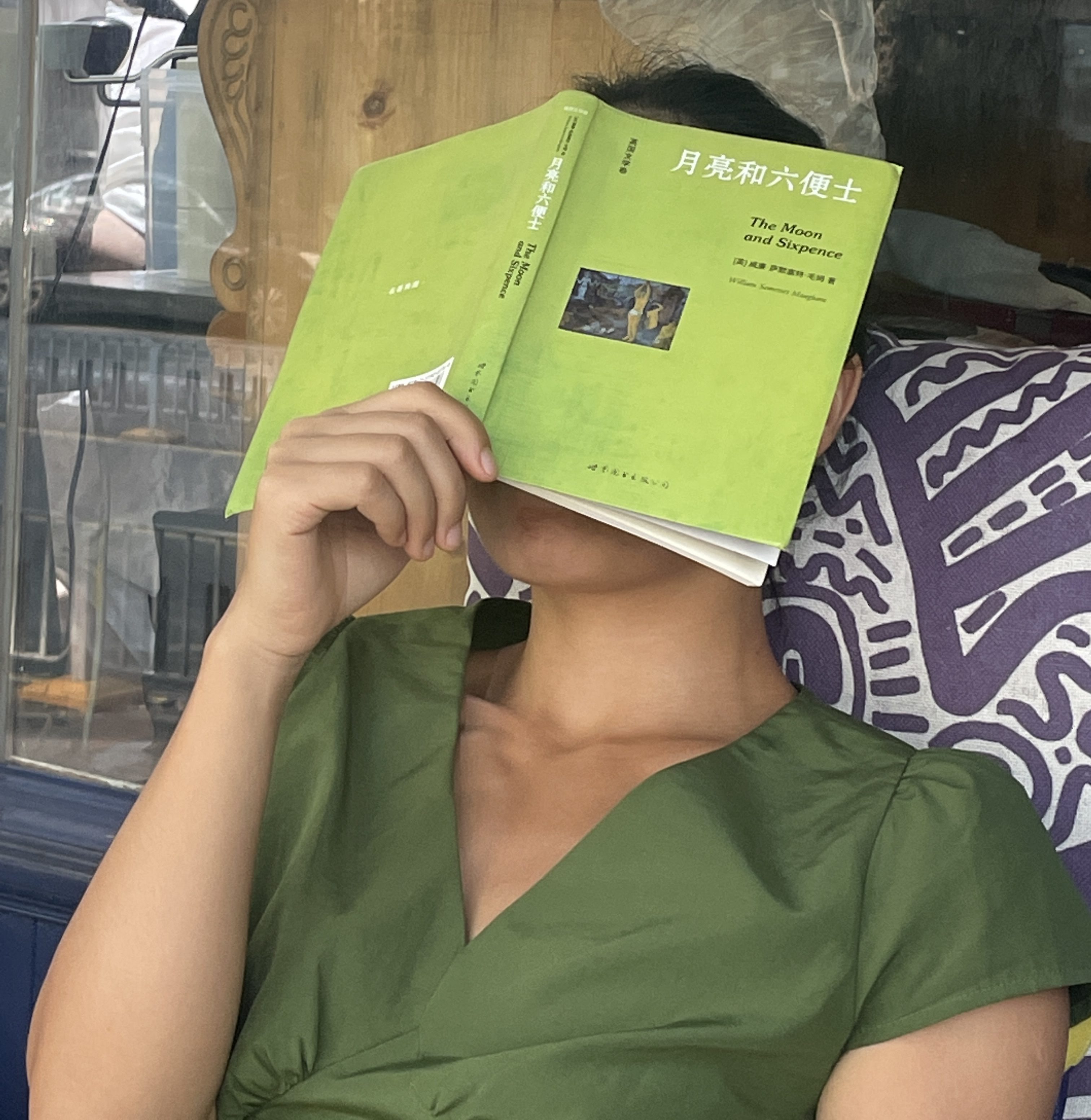 Covering face with a book
