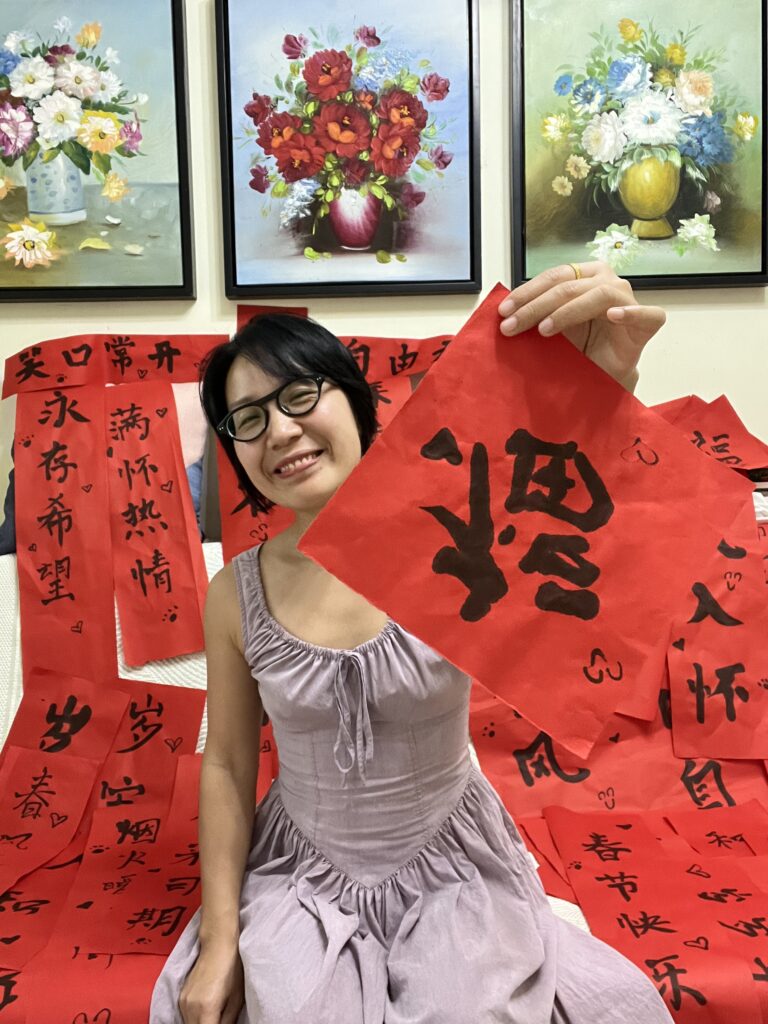 Falls holding her handwritten spring couplets.