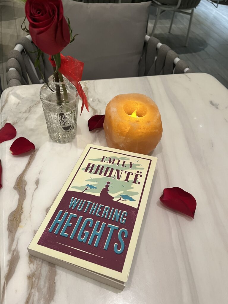 Wuthering Heights on the desk with candle and rose