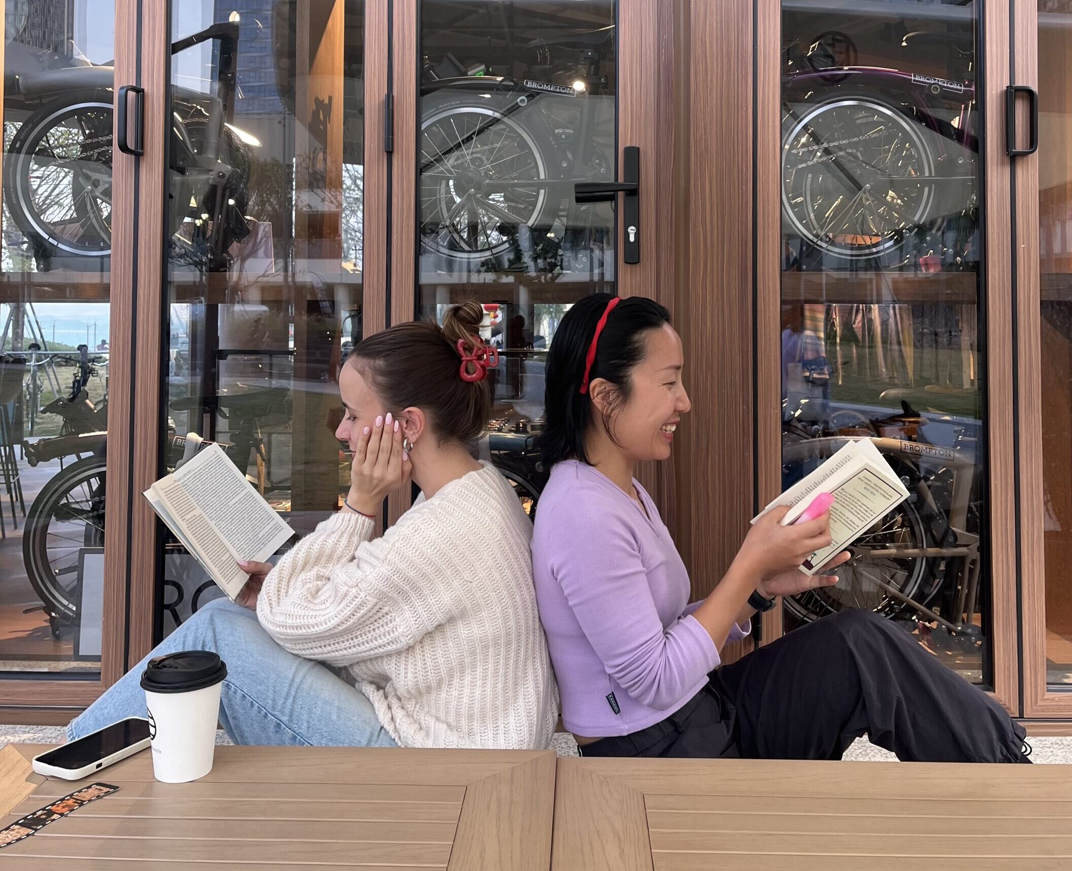 Falls and Nina sitting back to back reading