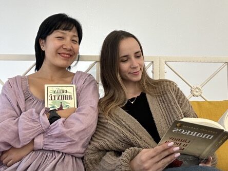 Two girls reading on a sofa