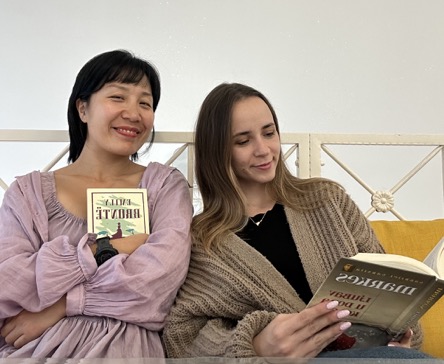 Two girls reading on a sofa