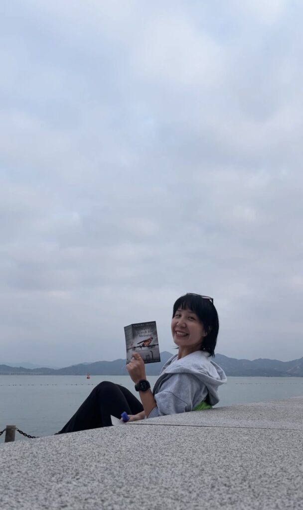 A girl reading by the sea