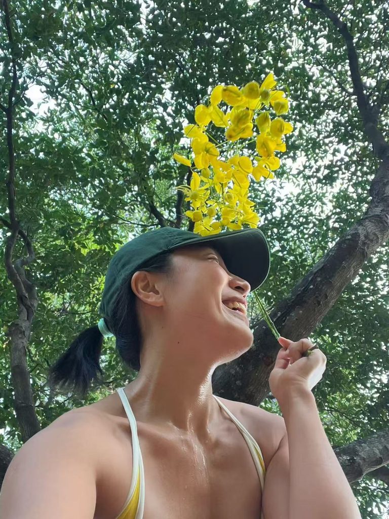 Falls sweaty and happy after a morning run under a tree.