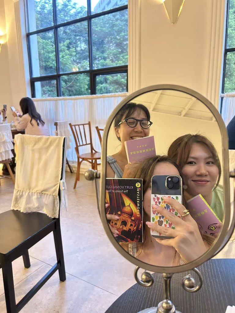 A cozy mirror selfie of members from the Felina Reading Club