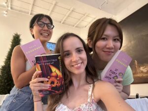 Group photo showing three members of Fallina reading club holding books
