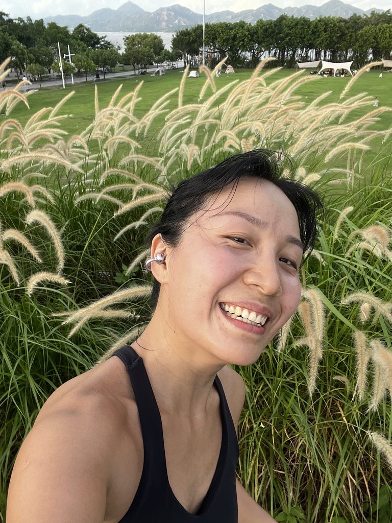 Falls smiling during a seaside run, celebrating personal growth and enjoying her own journey
