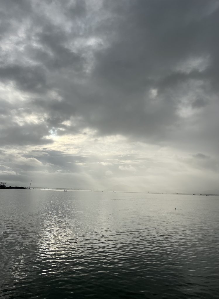 Morning sunlight breaking through clouds and reflecting on the sea