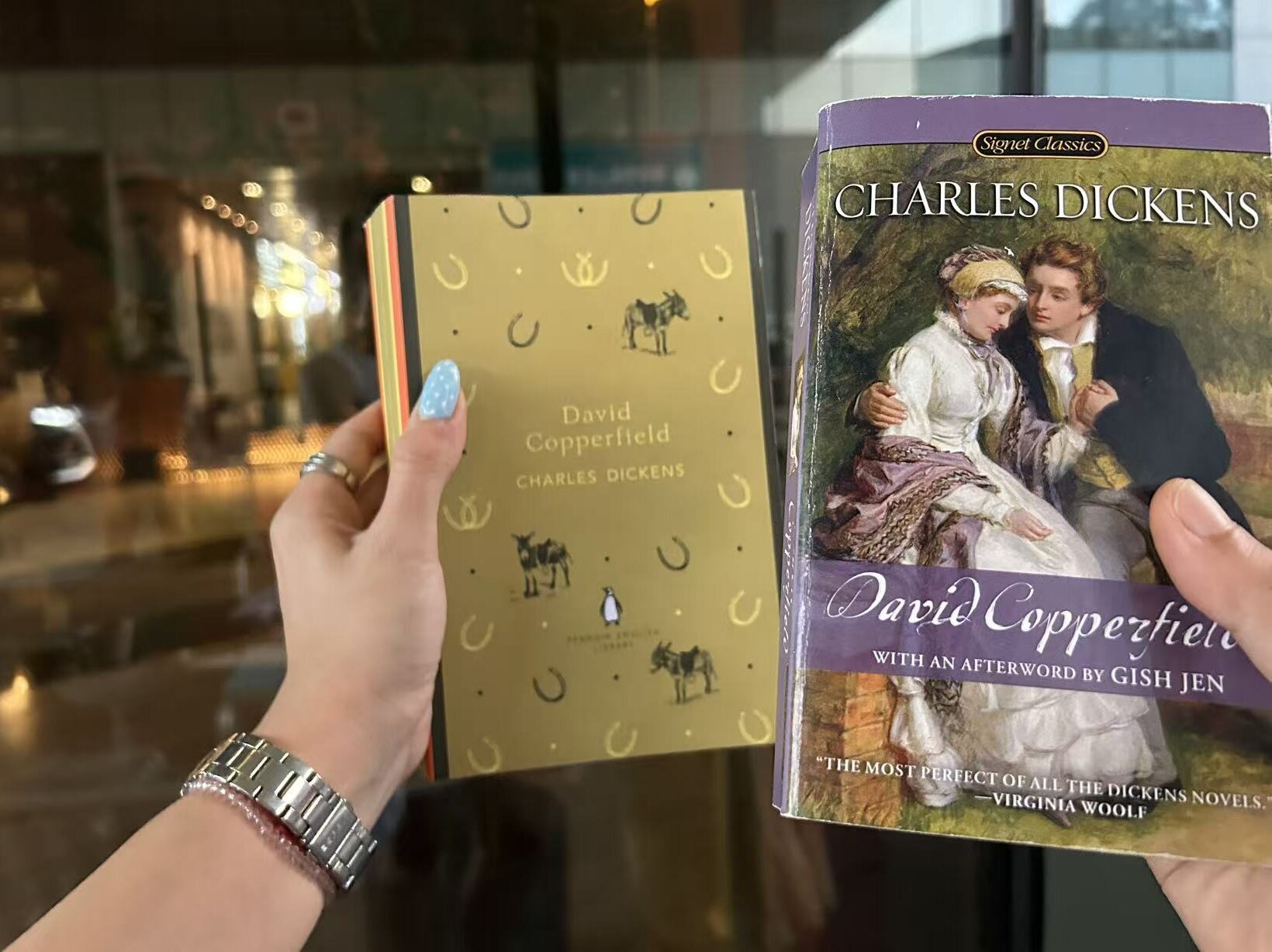 Falls and Nina holding their copies of Charles Dickens books during a Fallina reading session