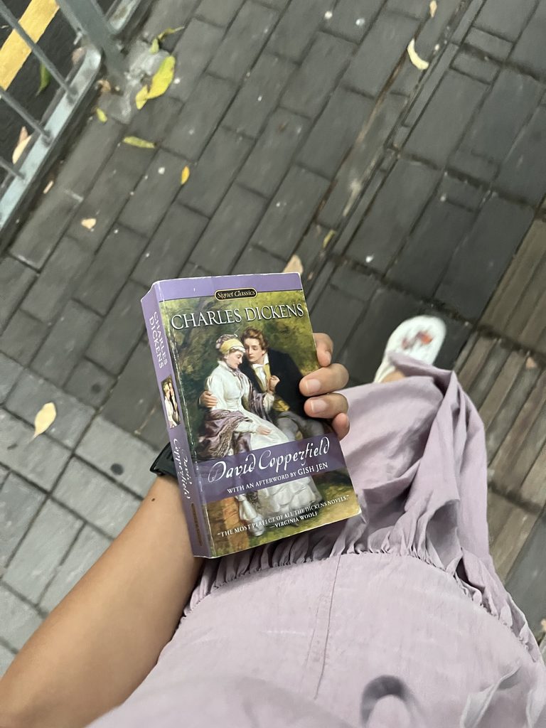 Walking with a copy of David Copperfield in hand
